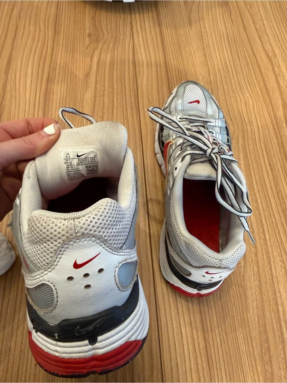 Nike Silver Athletic Shoes with Red and Gold Swoosh